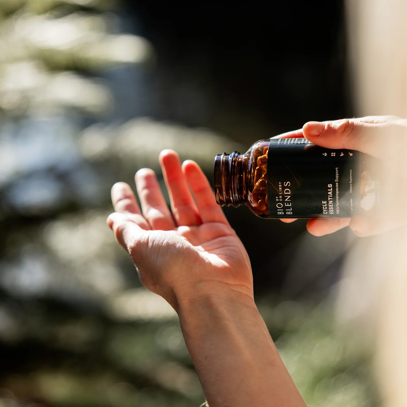 Bio blends cycle essentials supplement being poured into a hand