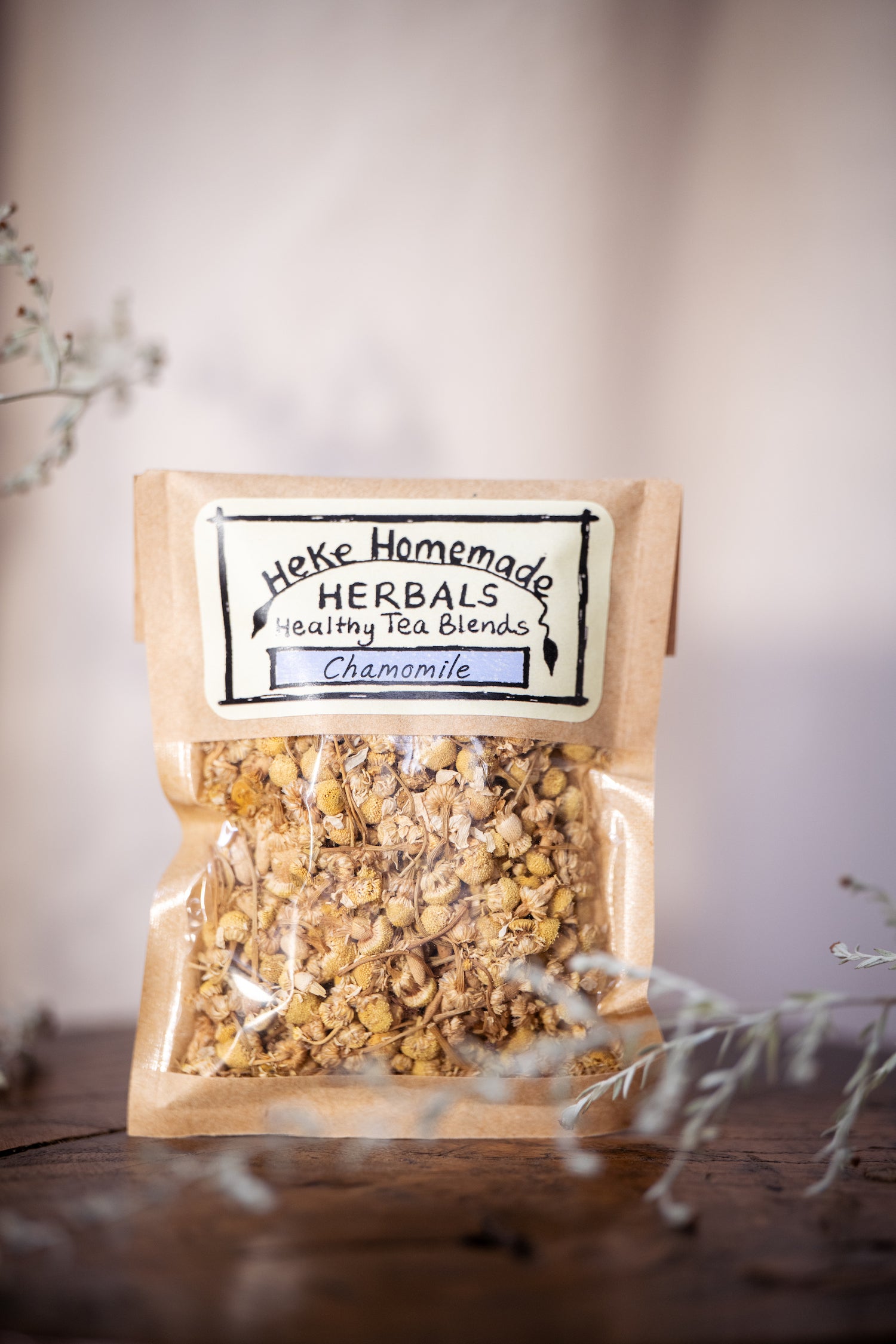 Packaged chamomile tea by Heke Herbals, with the product visible through a clear window.