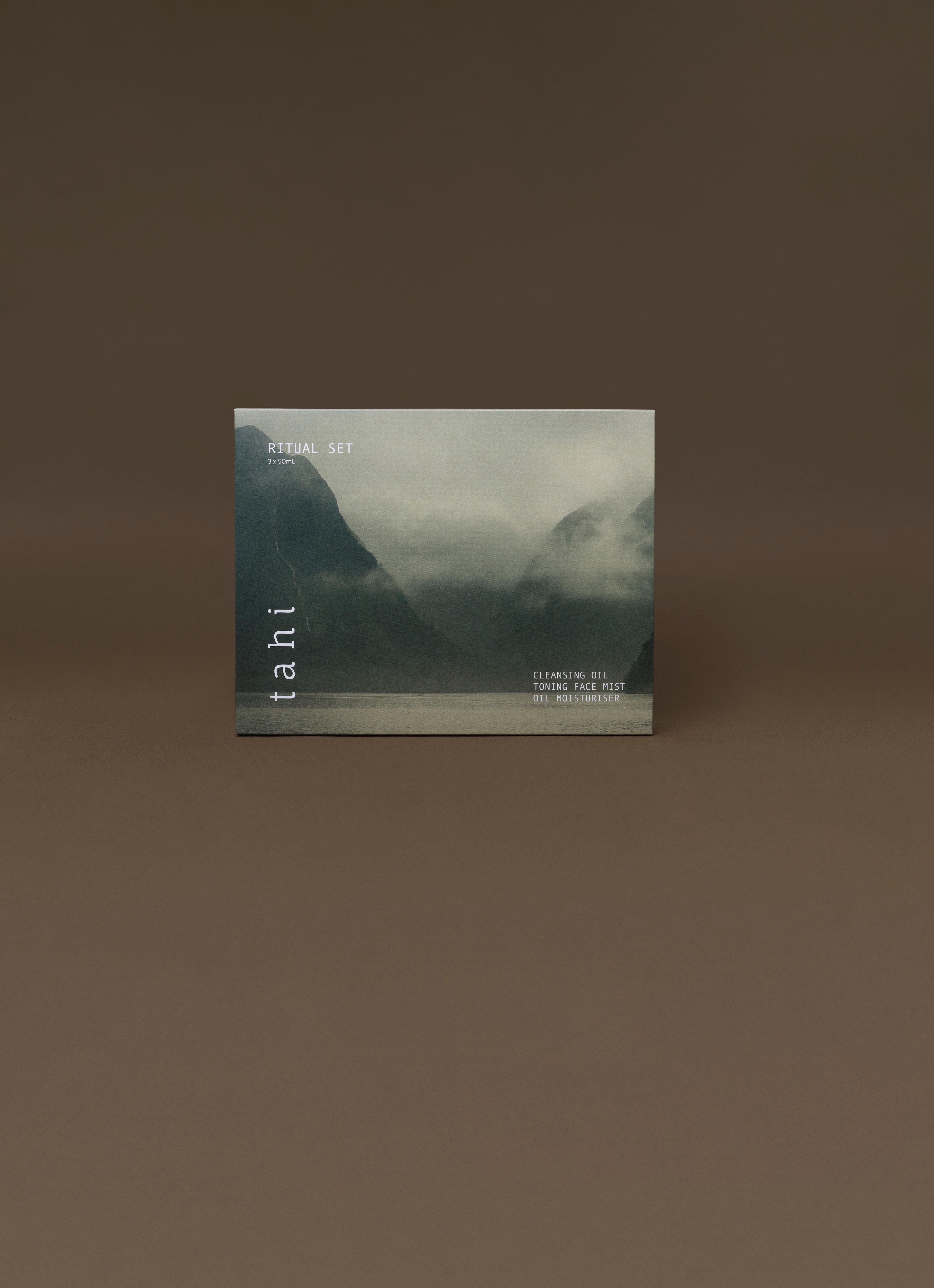 Product packaging of Tahi skincare with mountain landscape on a brown background