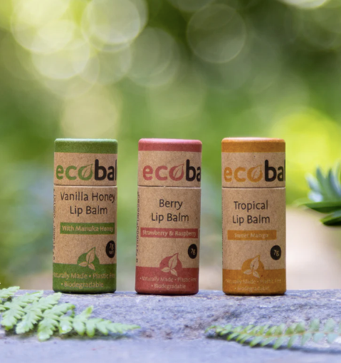 Three Ecobalm lip balms in colorful packaging on a natural background.