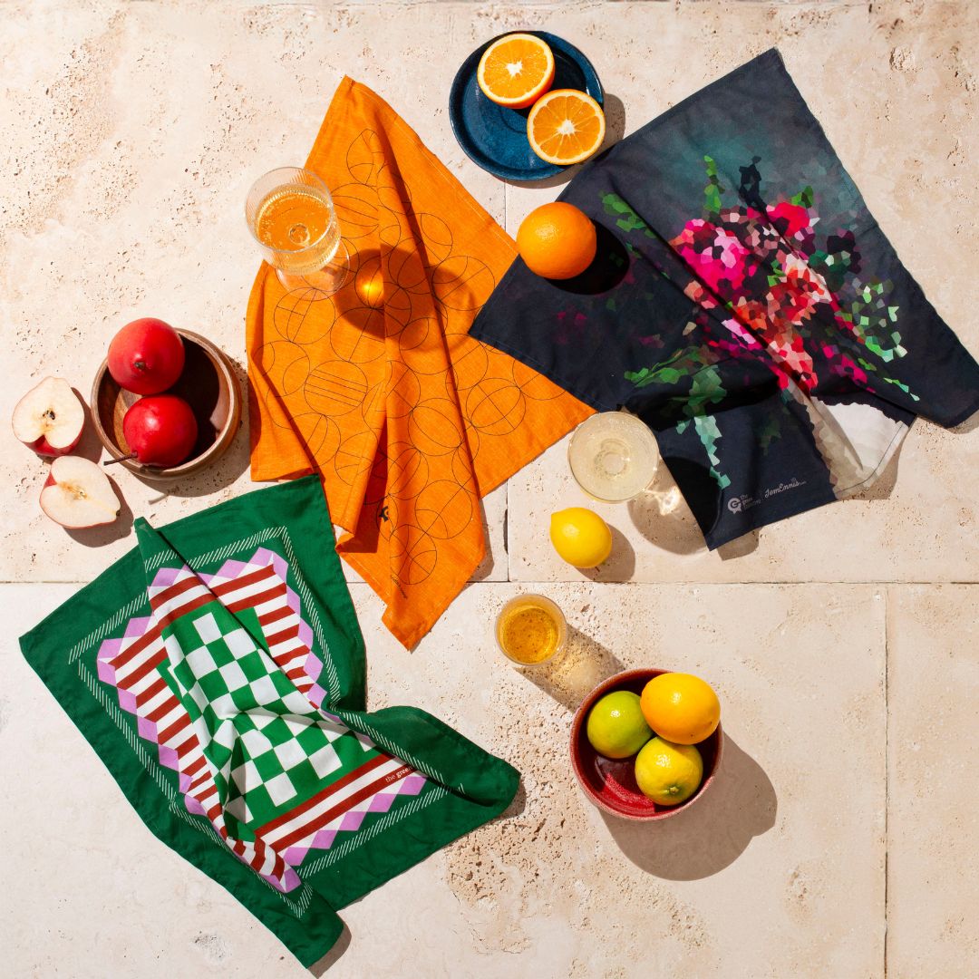 A collection of HANK by the Green Collective hankies displayed on a table with fruit
