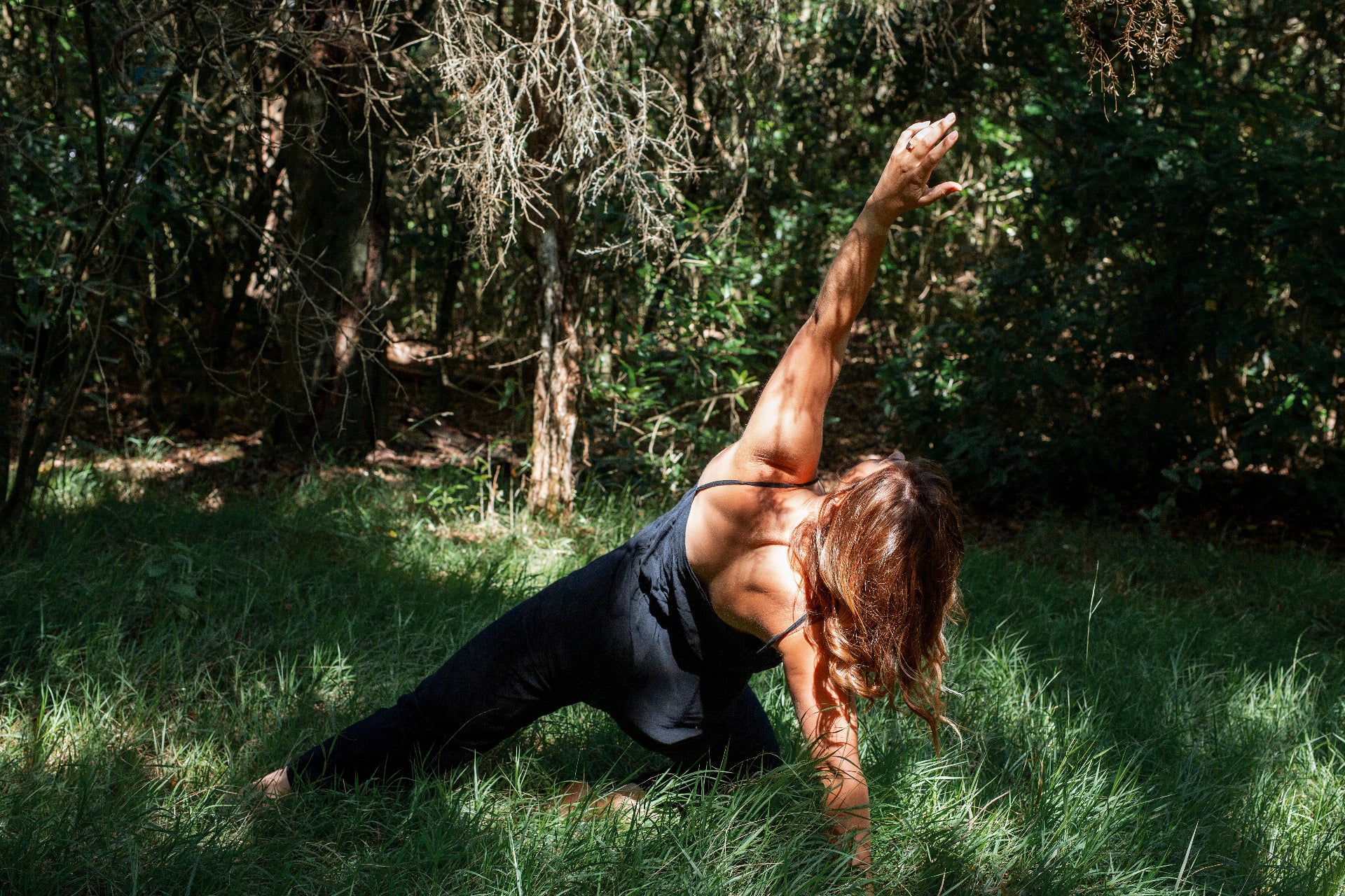 Steph from Woven for wellness doing yoga in a forest