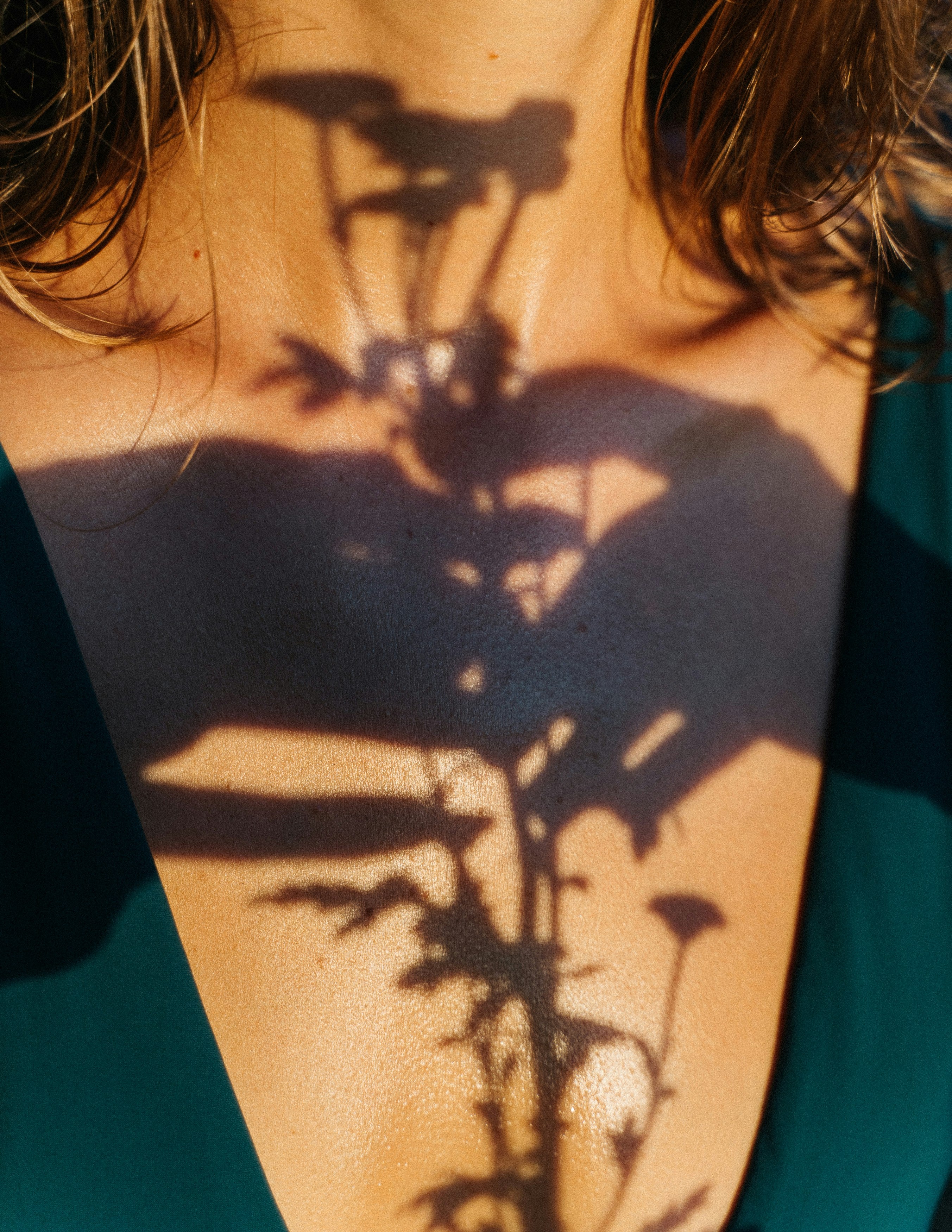 Shadow of flowers on a woman's torso