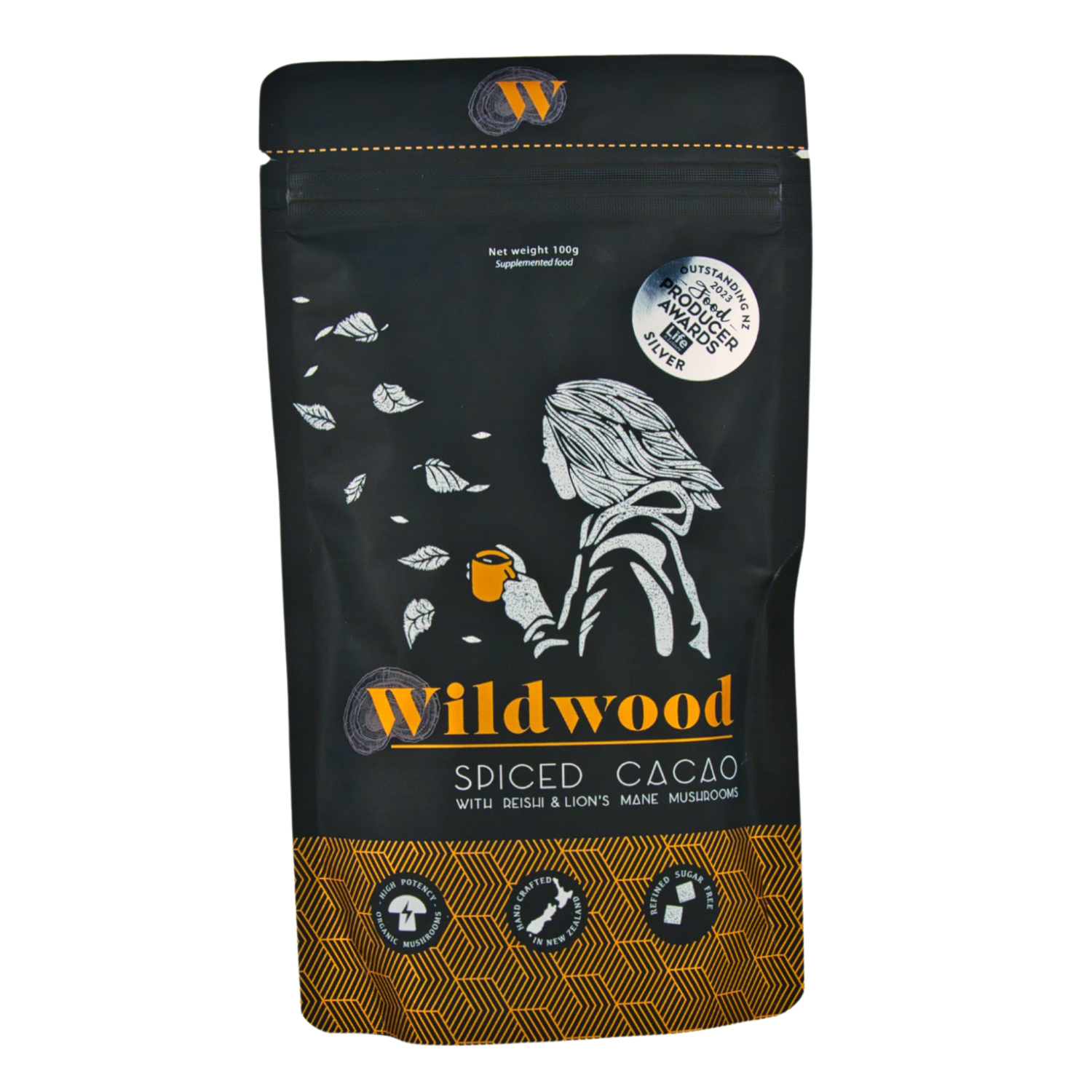 A package of Wildwood Spiced Cacao with illustrations of cacao beans and a silhouette of a woman on the front. The packaging is black with gold and white text and accents.