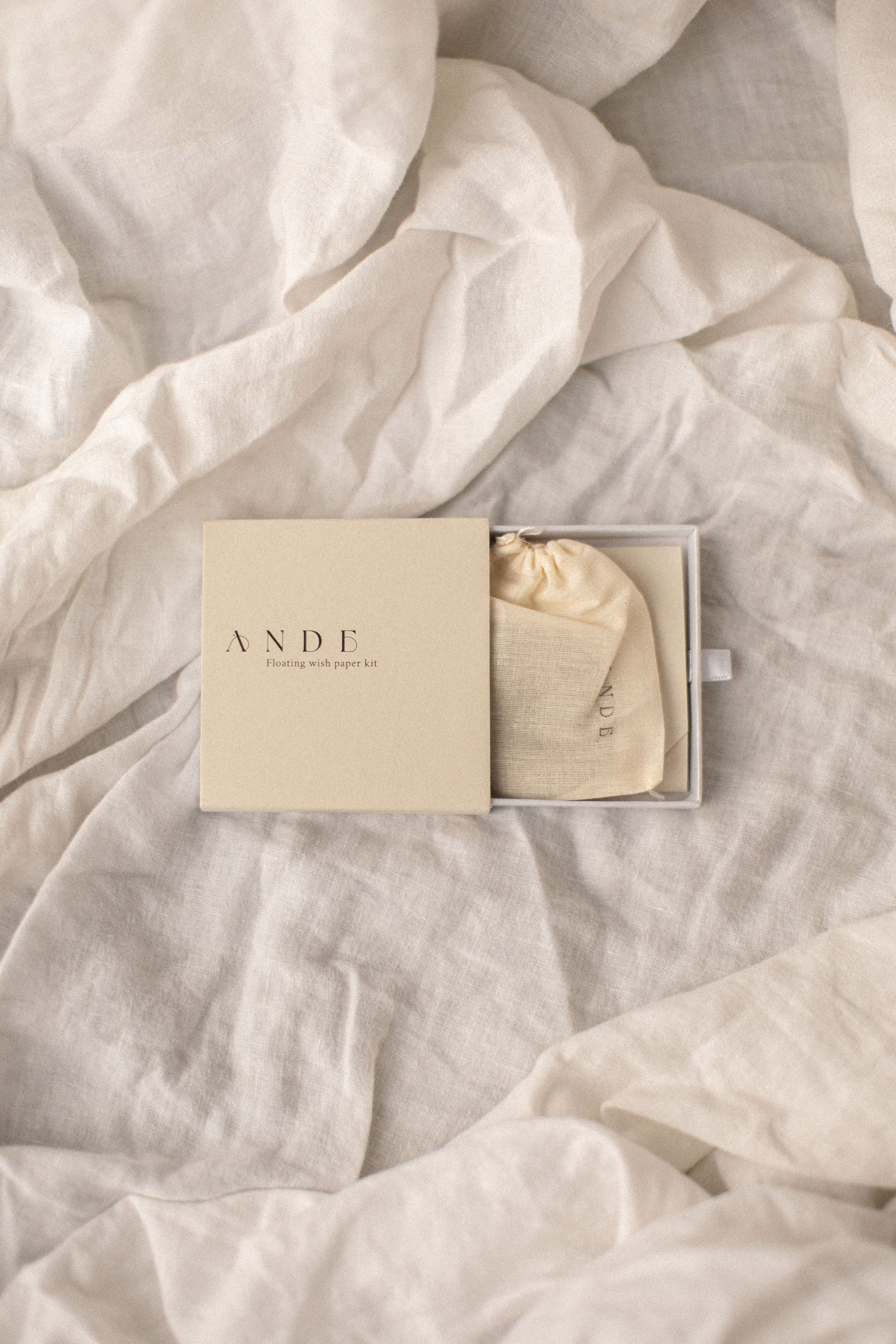 Ande floating wish paper kit - partially open on a white linen cloth