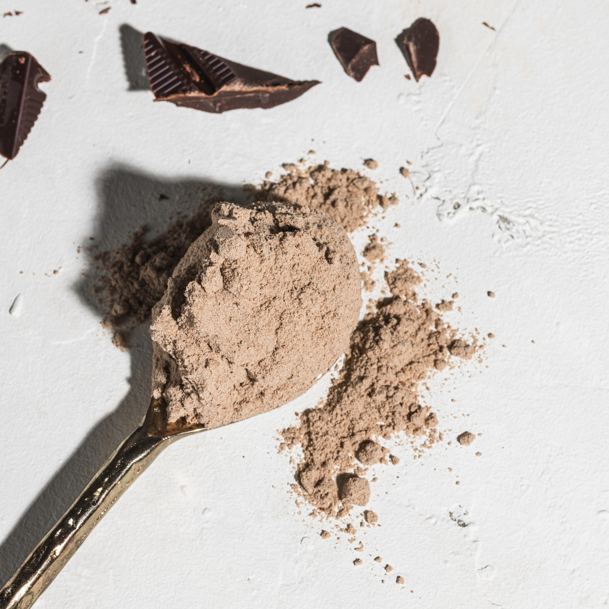 Second Nature Double Choc Fudge Pea Protein powder on a spoon