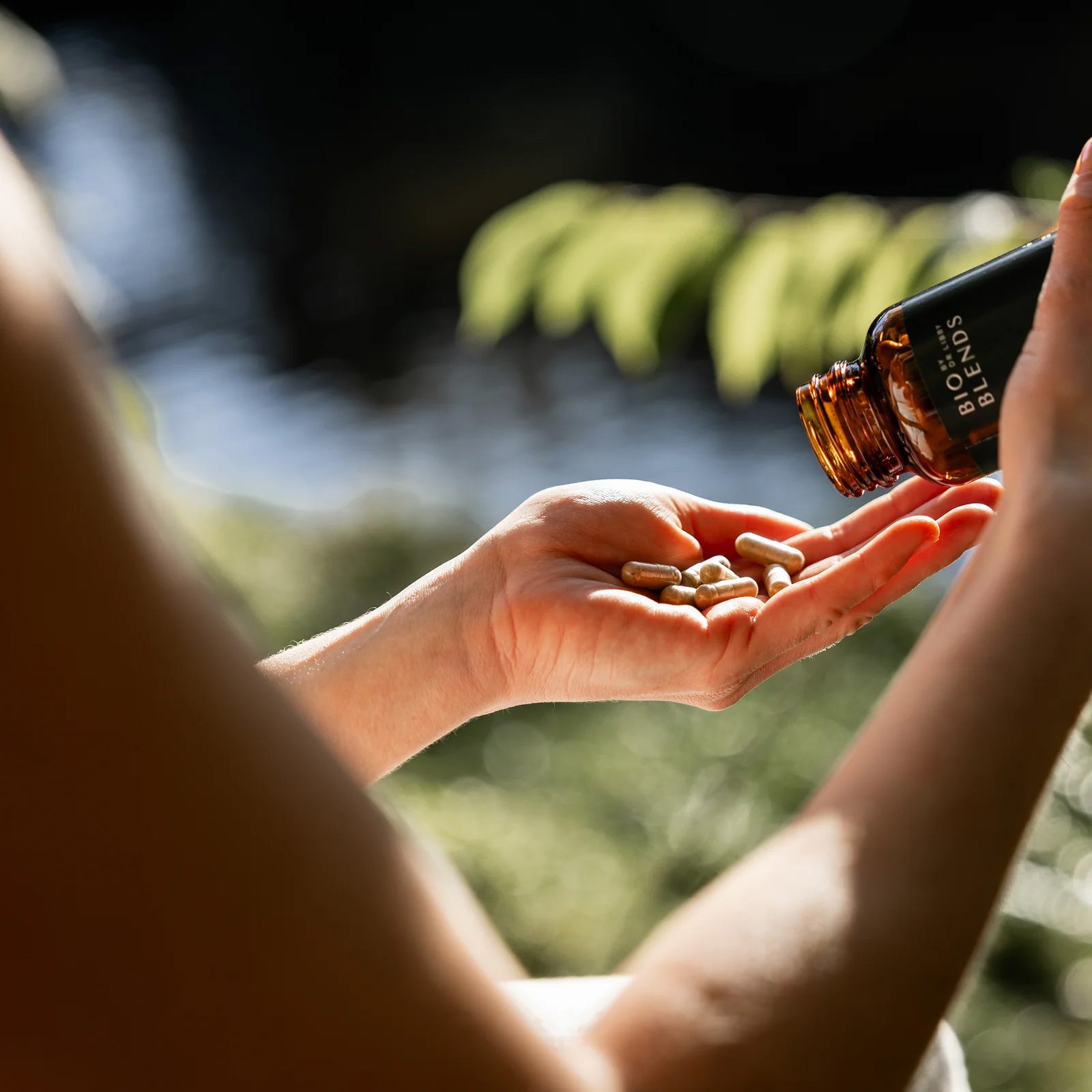 Bio Blends calm restore supplement being poured into a woman's hands