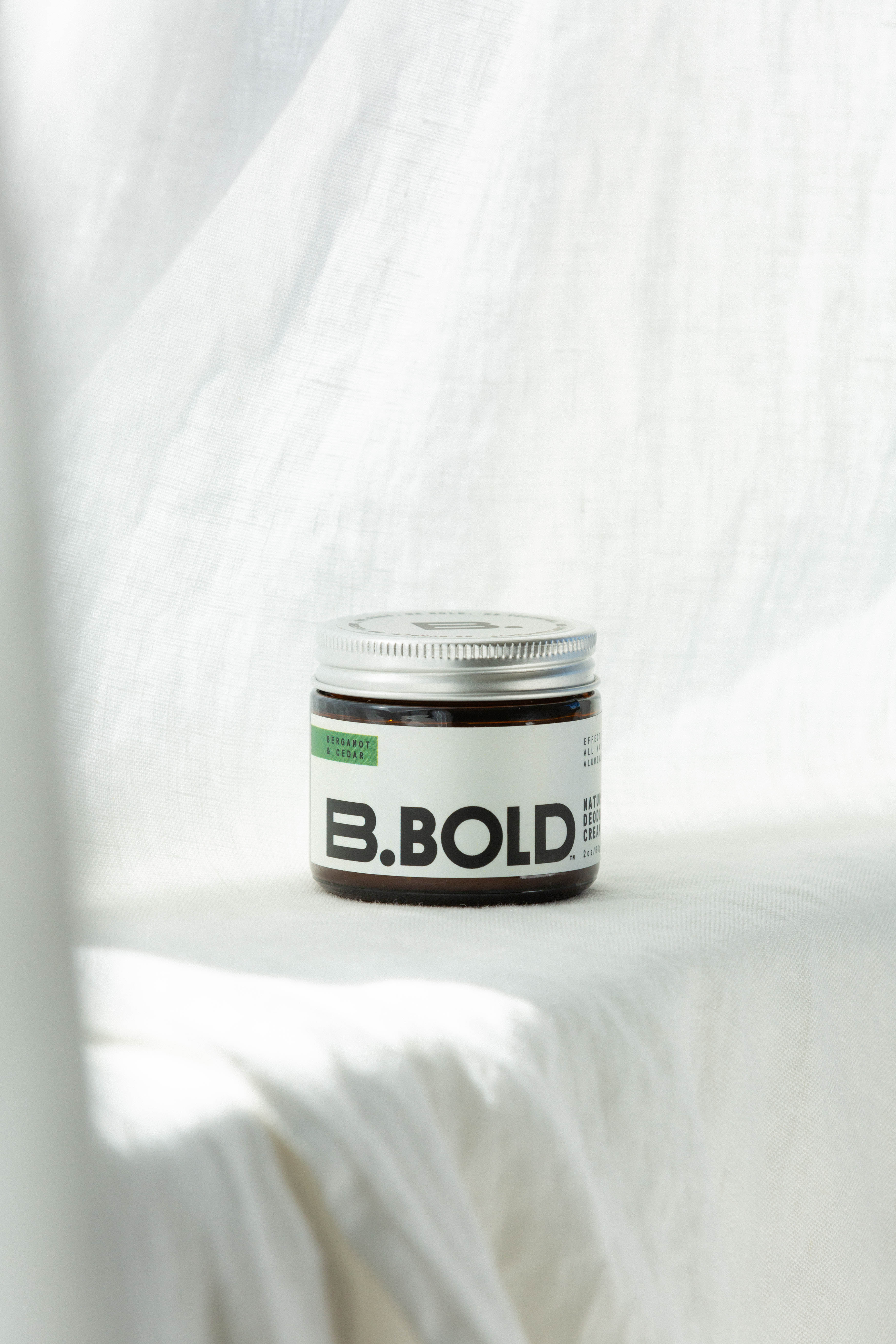 B.bold natural bergamot and cedar deodorant on white background