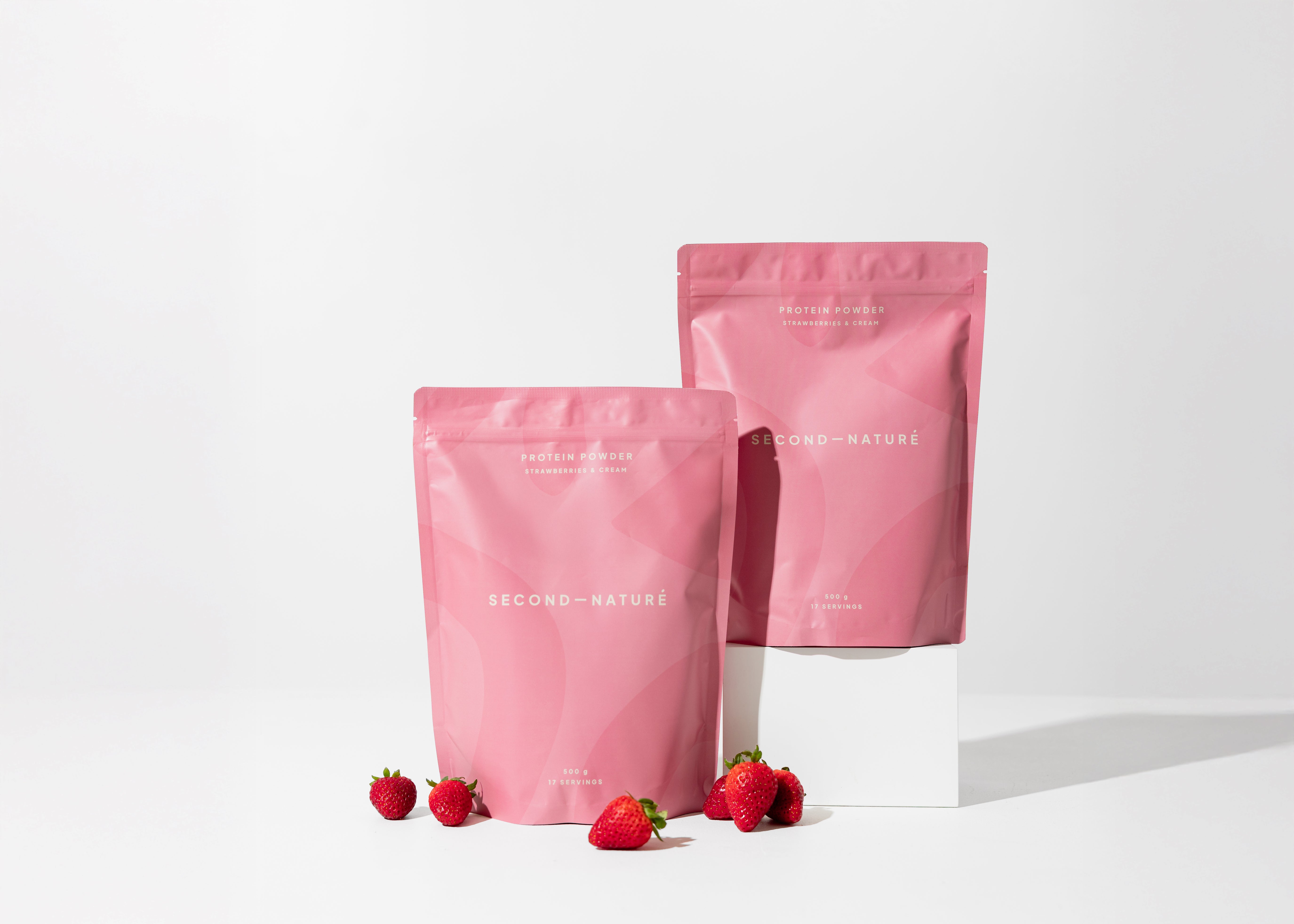 Second Nature Protein powder - two pink packages with strawberries on a white background