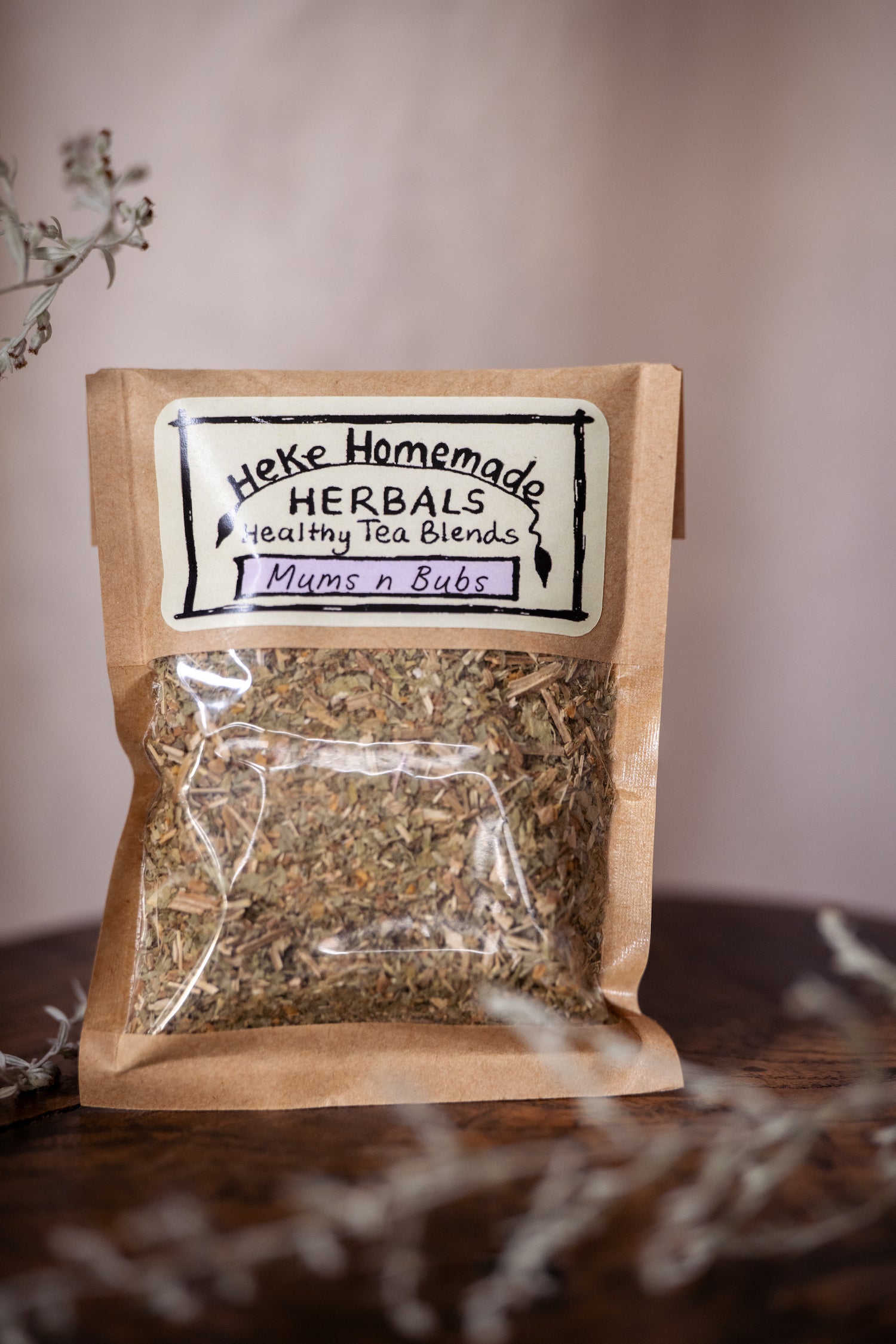 Packaged tea blend labeled 'Heke Herbals - Mums n Bubs Tea' with visible dried herbs through the transparent packaging.