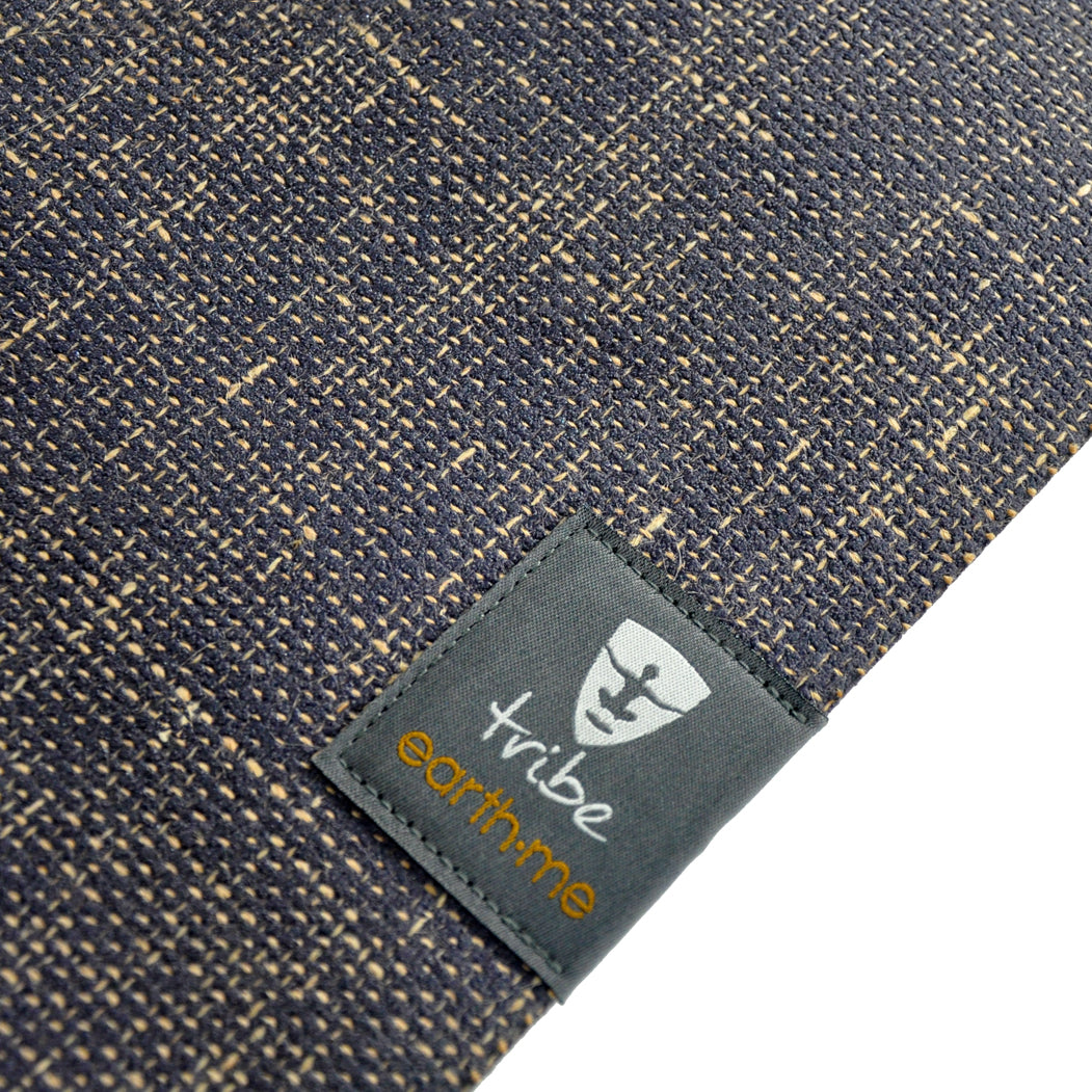Yoga mat with 'tribe earthme' label on a white background