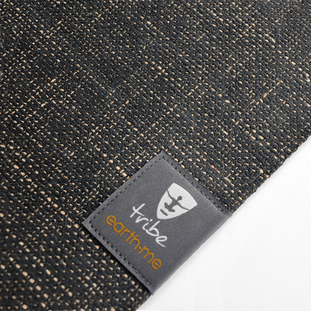 Jute yoga mat with a 'Tribe Earth me' label on a white background
