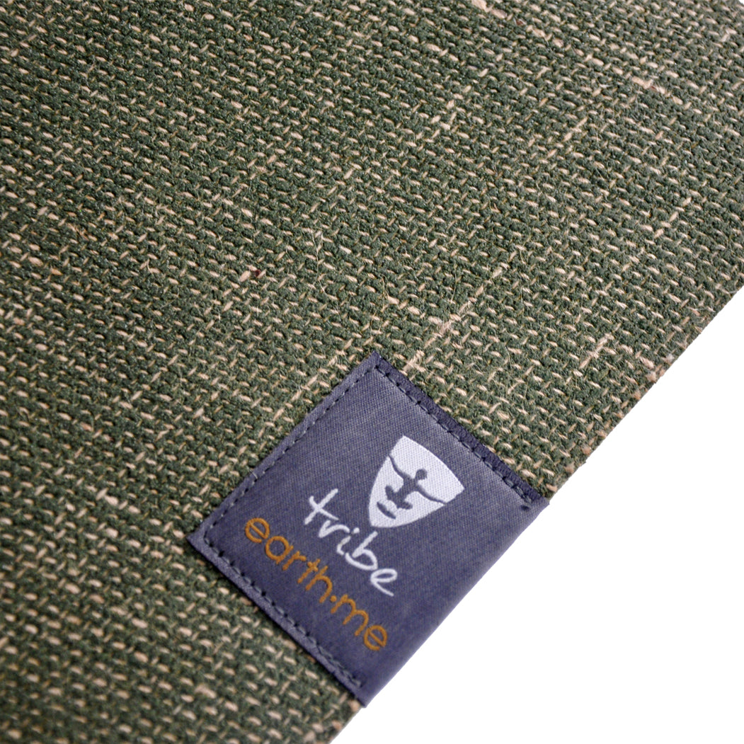 Jute yoga mat with a label 'tribe, earth me' on a white background